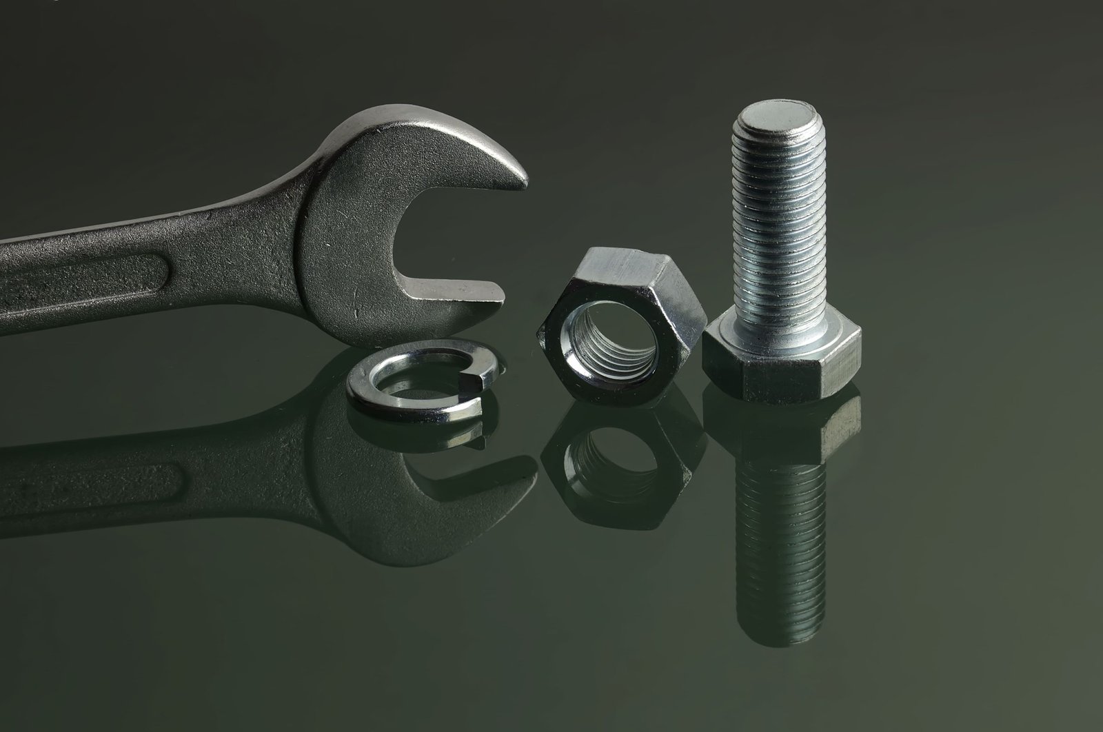 vecteezy-wrench-and-mechanical-fasteners-on-reflective-surface-48762074